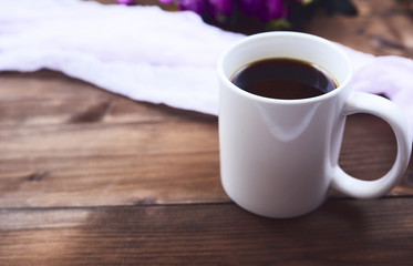 Close-up view of cup of black coffee over wooden board