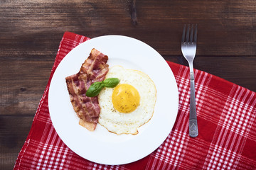 tastu fried egg in plate with bacon