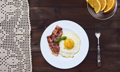 tastu fried egg in plate with bacon