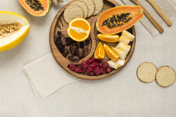 Natural fruit dessert on a wooden plate flatlay