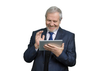 Cheerful smiling businessman with tablet device. Portrait of happy old senior man in business suit using portable computer device. White Isolated background.