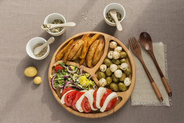 Vegetarian snacks on a wooden plate flatlay