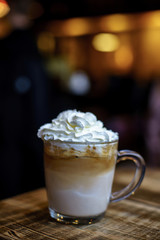 Ice Coffee Latte with Cream on blurry background