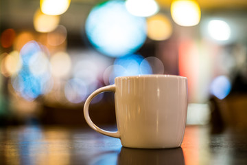 Coffee Lattee on the wooden table with back light