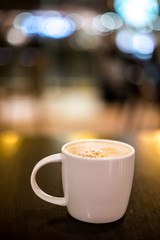 Coffee Lattee on the wooden table with back light