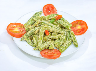 Popular non vegetarian Indian food made from ladies finger with white mustard gravy garnished with green chilli and tomato