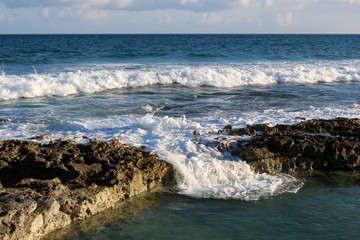 Foaming wave flows into the lagoon/ Caribbean sea, Yucatan beach, Puerto Aventuras, Mexico