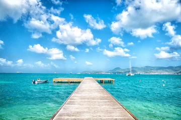 Fotobehang Pier in turquoise sea and blue sky with white clouds in philipsburg, sint maarten. Freedom, perspective and future. Beach vacation at Caribbean, wanderlust © be free