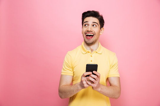 Portrait Of A Happy Young Man Holding Mobile Phone