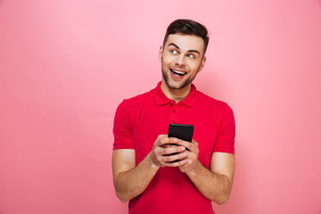 Portrait of a happy young man holding mobile phone