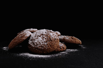 oatmeal cookies on a black table in castor sugar