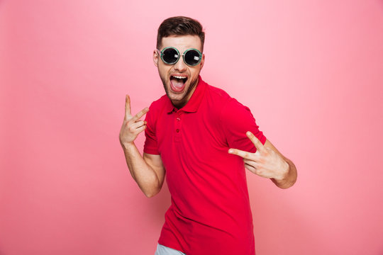 Portrait of an excited young man in sunglasses