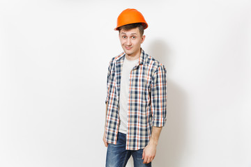 Young fun handsome man in casual clothes and protective construction orange helmet isolated on white background. Accessories for renovation apartment room. Repair home concept. Advertising area.