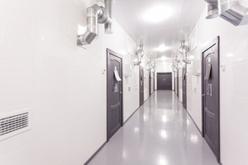 white corridor with dark doors