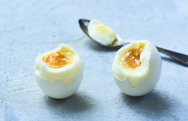 tasty boiled eggs over rustic background