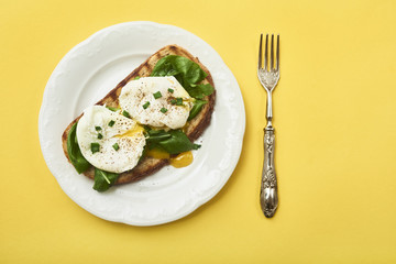 Tasty poached egg on toast over rustic background
