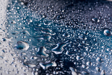 Colored water droplets on a gold background. Abstract liquid sprays