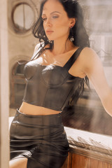 Fototapeta na wymiar sexy beautiful woman with dark hair and evening makeup, in elegant clothes