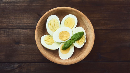 tasty boiled eggs over rustic background