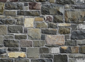 stone wall with different size and colors of stone bricks, for backgrounds 
