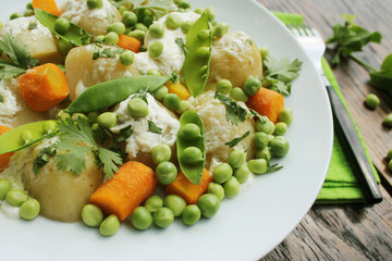 Potato salad with carrots, peas and coriander
