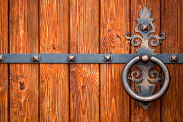 wooden gate with wrought iron elements close up