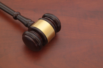 Wooden judge gavel on brown wooden table with space for text