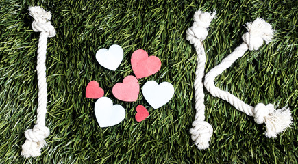 I Love K rope text layed on green grass surface.