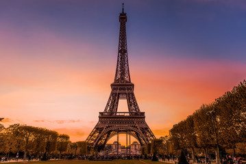 Eiffel tower in Paris at dusk, with sky of various colors