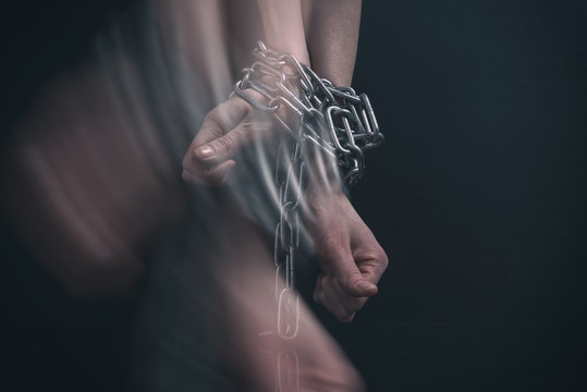 women's hands chained, break out in motion, double exposure effect