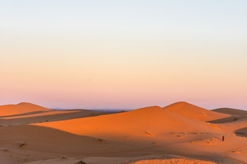 Fototapeta na wymiar Berber at sunrise on the sand dunes