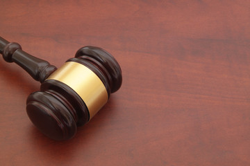 Judge gavel on brown wooden table 