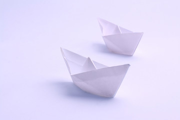 two white boat , made in the technique of origami