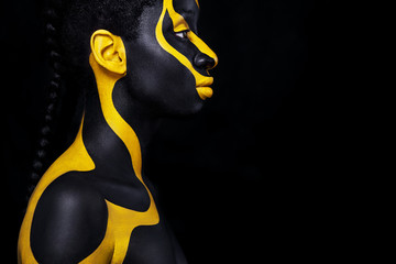 Cheerful young african woman with art fashion makeup. An amazing woman with black and yellow makeup