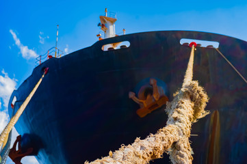 Oil tanker ship at sea on a background of sunset sky. dockyard, front, harbor, harbour, hull,...