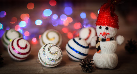 Christmas balls and a toy snowman on Christmas table