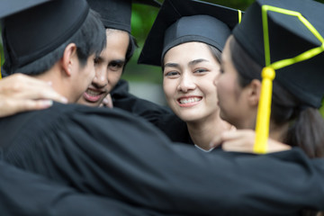 Graduation day,Happily graduates are celebrating graduation, a certificate and a hat in hand, Happiness feeling, Commencement day, Congratulation. Education Concept.