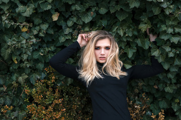 the girl in leaves posing for photo