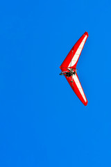 Naklejka premium The motorized hang glider in the blue sky
