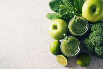 Green smoothie with ingredients, apples, lime, broccoli and spinach. Clean eating