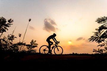 Fototapeta na wymiar Silhouette of cyclist on beautiful sky ,Man ride bicycle on sunset background