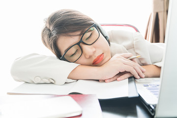 Teenage girl short hair sleep on desk after working
