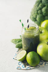 Green smoothie with ingredients, apples, lime, broccoli and spinach. Clean eating