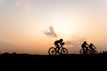 Obraz premium Silhouette of cyclist on beautiful sky ,Man ride bicycle on sunset background