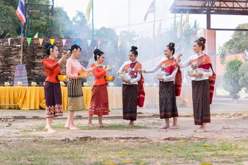 Obraz premium Beautiful Thai girl in Thai costume playing water in Songkran day.