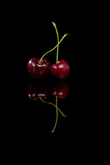 Red cherries on black background.
