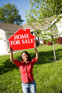 Home: Woman Holds Up For Sale Sign