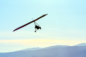 Fototapeta na wymiar The motorized hang glider in the blue sky