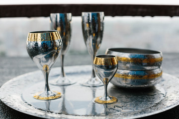 iron glasses on a tray, beautiful dishes, dishes and drops of water, rain