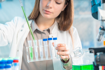 Chemical laboratory scientist woman working with pipette
